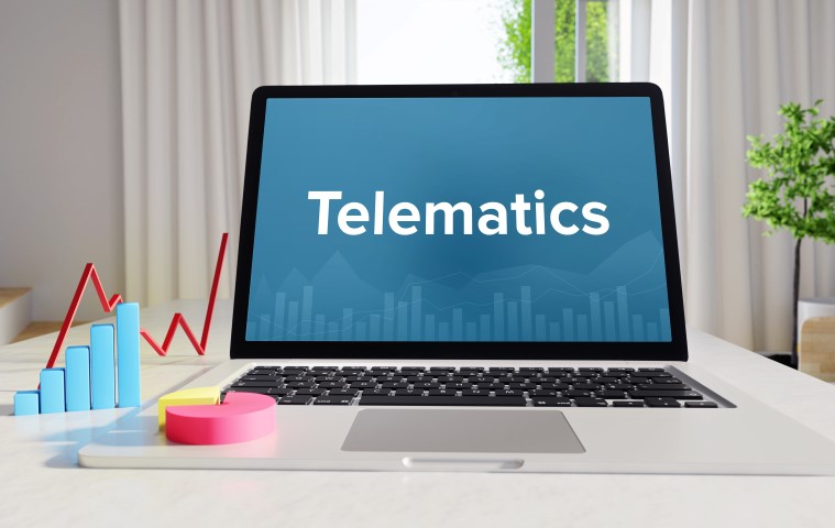 Telematics – Statistics/Business. Laptop in the office with term on the display. Finance/Economics.