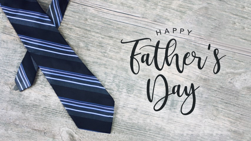 Happy Father's Day Text with Striped Tie Over Light Wood Background