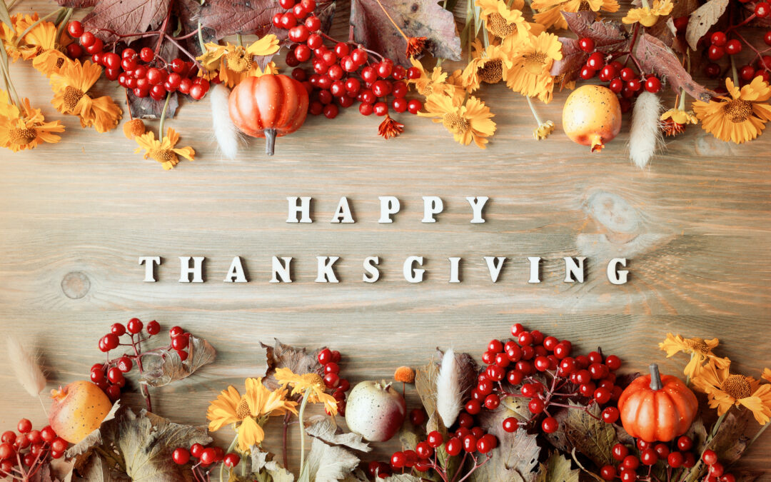 Thanksgiving day autumn background with Happy Thanksgiving letters, seasonal autumn nature berries, pumpkins, apples and flowers on the wooden background